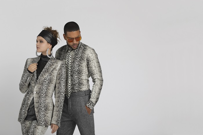 female and male models wearing python print clothing, in front of light gray backdrop