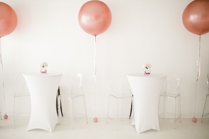 white tables with champagne oversized balloon