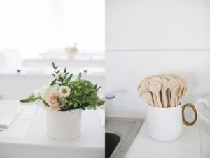 engraved wooden tea spoons in white ceramic canister