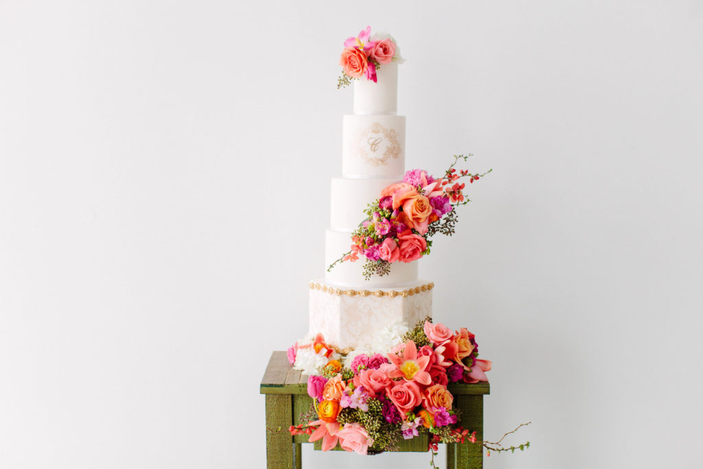 five tier wedding cake with tropical hued florals created by Sweet Details and Stylish Stems