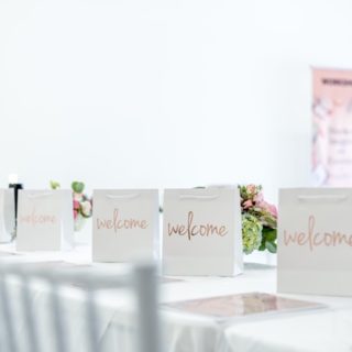 welcome bags, white event space, workshop banner