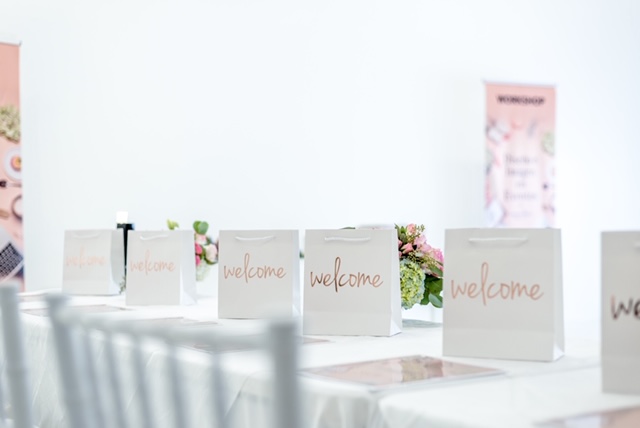 welcome bags, white event space, workshop banner