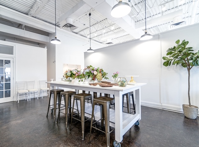 Park Studios Atlanta reception area, fiddle leaf fig, white bar cart, concrete floor